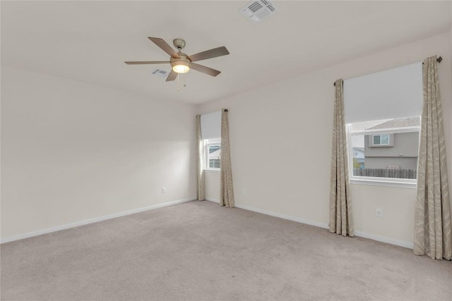 unfurnished room with baseboards, ceiling fan, visible vents, and carpet flooring