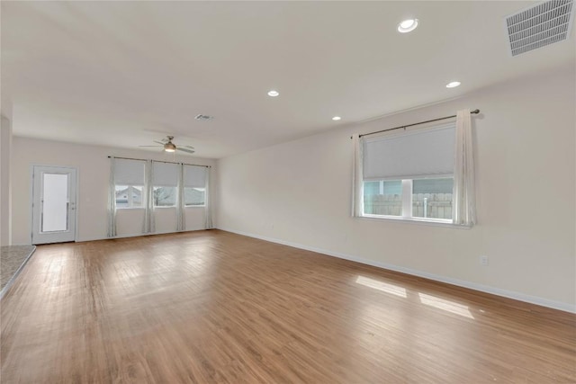 unfurnished room with light wood finished floors, baseboards, visible vents, ceiling fan, and recessed lighting