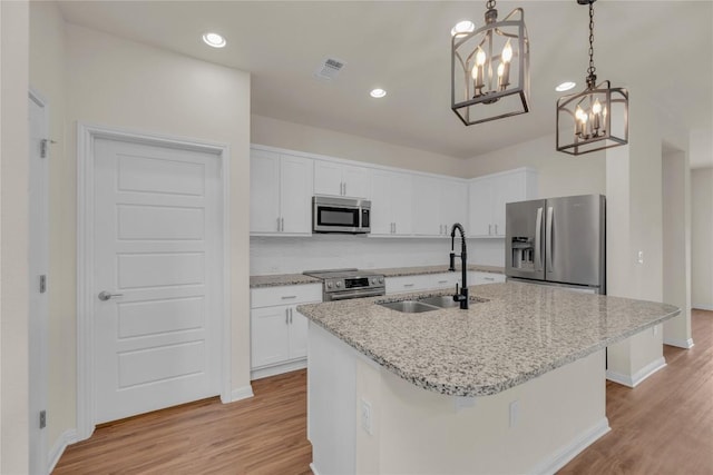 kitchen featuring light wood-style floors, visible vents, appliances with stainless steel finishes, and a sink