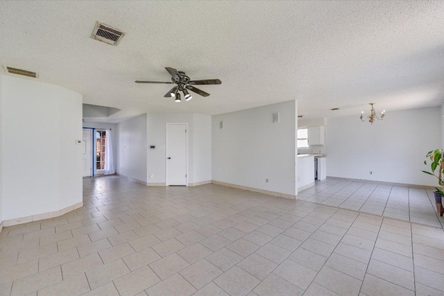 unfurnished room featuring ceiling fan with notable chandelier, visible vents, a textured ceiling, and light tile patterned floors