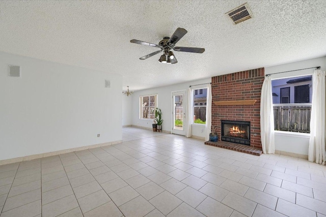 unfurnished living room featuring tile patterned flooring, visible vents, ceiling fan, and a fireplace