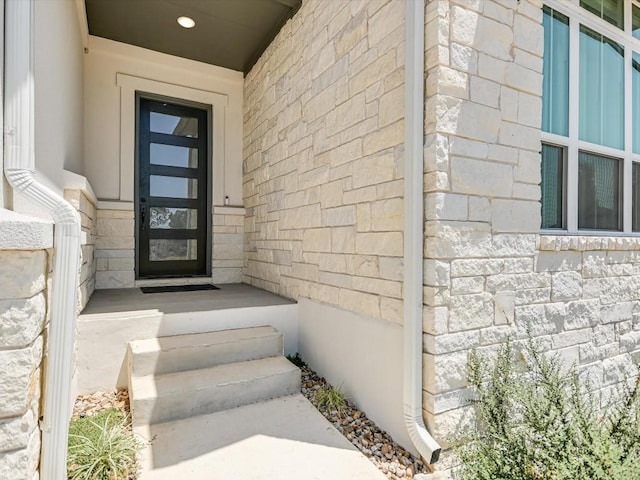 property entrance with stone siding