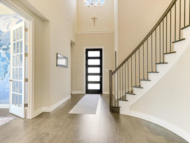 foyer featuring stairway, baseboards, and dark wood-style flooring