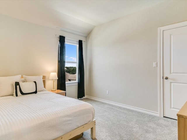 bedroom featuring carpet flooring, vaulted ceiling, and baseboards