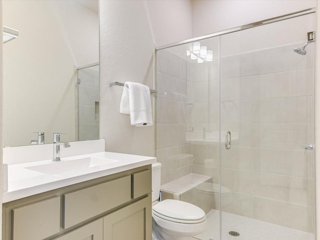 full bath featuring vanity, a shower stall, and toilet