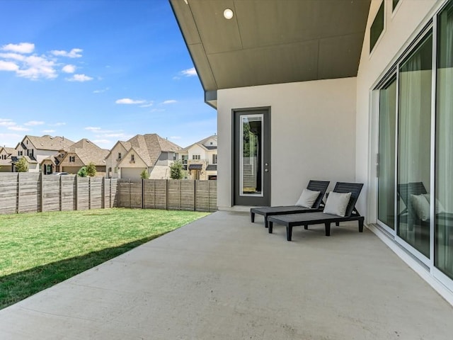 view of patio with a residential view and fence