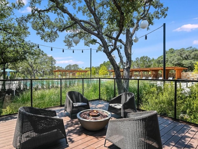 deck featuring an outdoor fire pit