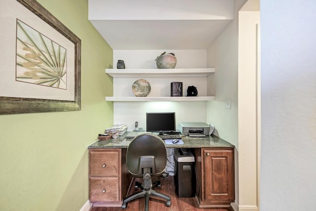 home office with built in desk, baseboards, and wood finished floors