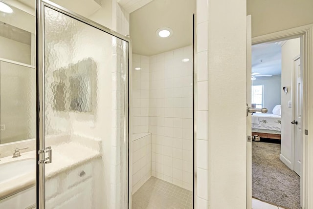 ensuite bathroom with a shower stall and connected bathroom