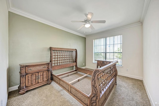 carpeted bedroom featuring crown molding, baseboards, and ceiling fan