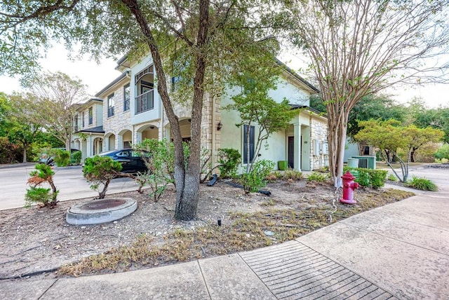 view of front of home featuring cooling unit and stucco siding