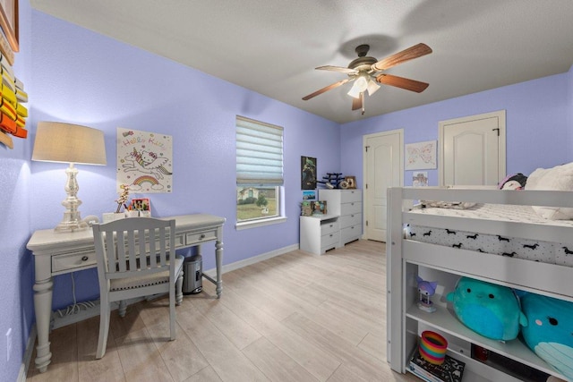 bedroom featuring baseboards, ceiling fan, and light wood-style floors