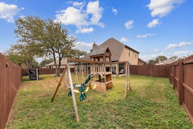 view of playground with a fenced backyard and a lawn