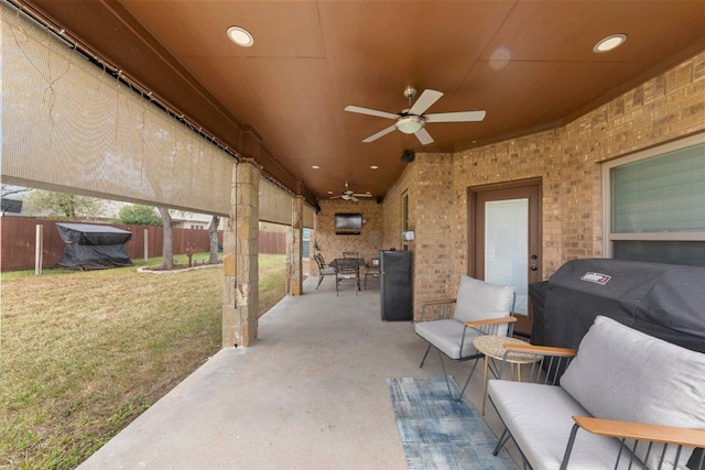 view of patio featuring grilling area, fence, and a ceiling fan