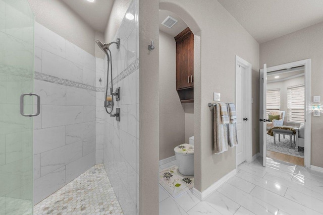 ensuite bathroom with marble finish floor, toilet, ensuite bath, tiled shower, and baseboards