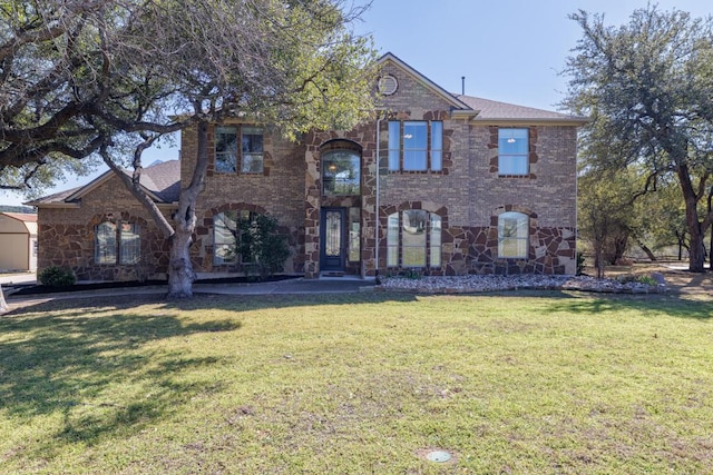 view of front of property featuring a front yard and brick siding