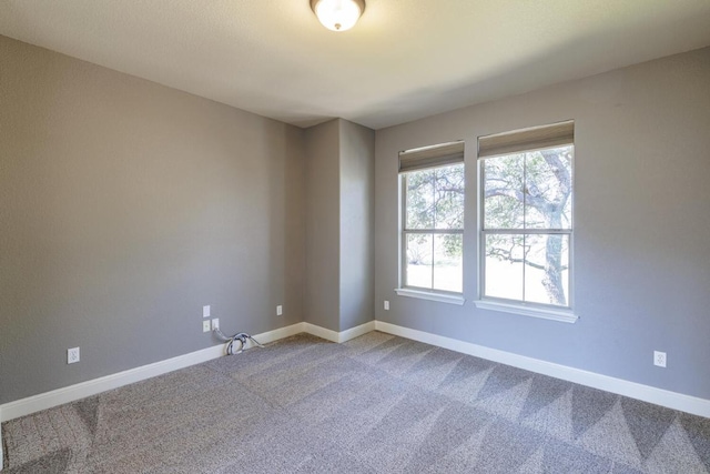 spare room with carpet floors and baseboards