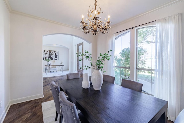 dining area with dark wood-style floors, baseboards, arched walkways, and crown molding