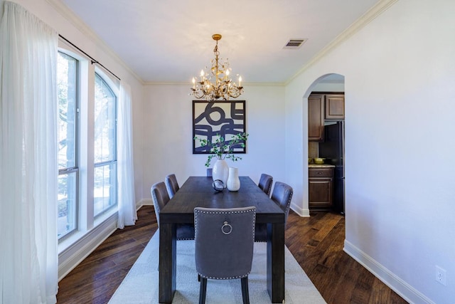 dining room featuring a healthy amount of sunlight, dark wood-style floors, baseboards, and visible vents