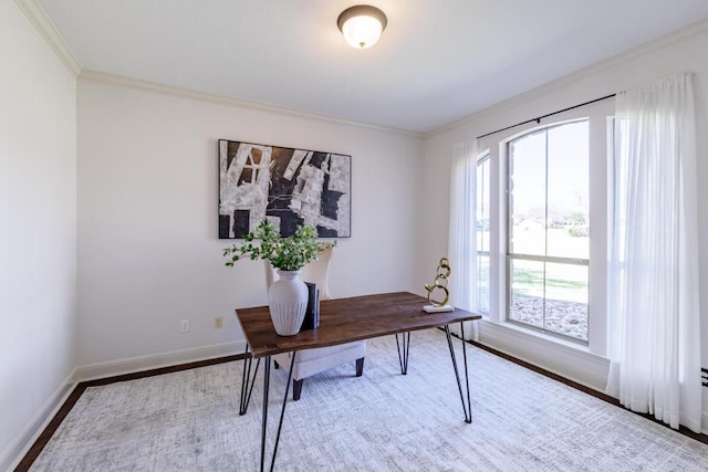 office space with baseboards, wood finished floors, and crown molding