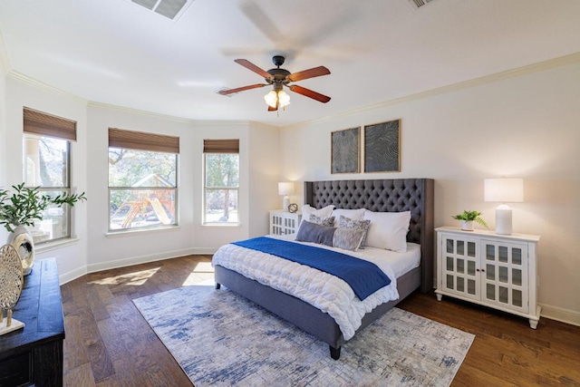 bedroom with ornamental molding, wood finished floors, visible vents, and multiple windows