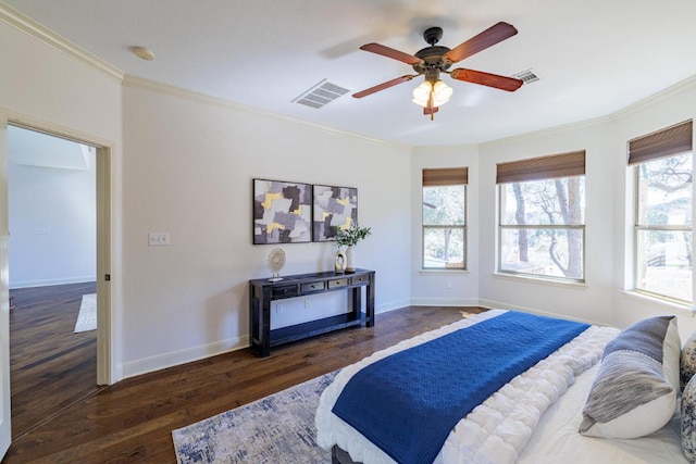 bedroom featuring visible vents, crown molding, and wood finished floors