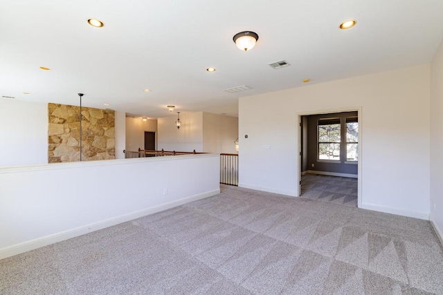 carpeted empty room with recessed lighting, visible vents, and baseboards