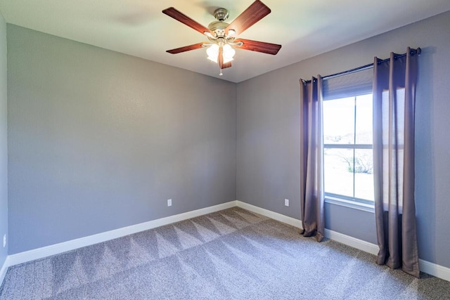 empty room featuring carpet floors, ceiling fan, and baseboards