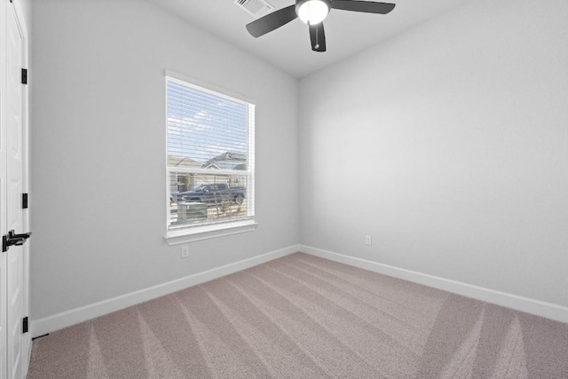 spare room featuring a ceiling fan, carpet flooring, and baseboards