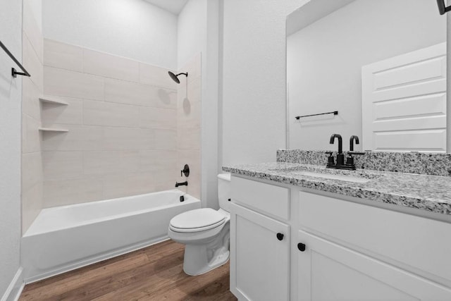 bathroom featuring shower / tub combination, vanity, toilet, and wood finished floors