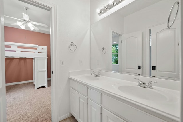 full bathroom with a ceiling fan, a sink, baseboards, and double vanity