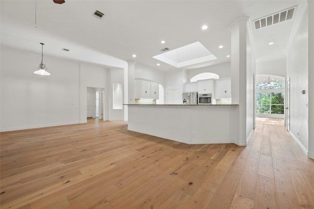 kitchen featuring light wood finished floors, appliances with stainless steel finishes, and visible vents