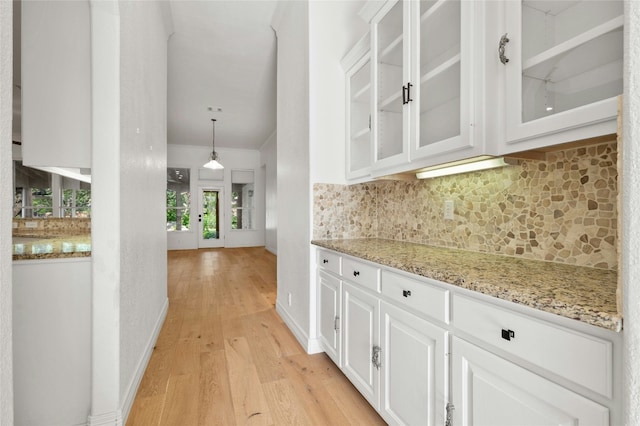 interior space with light wood finished floors and baseboards