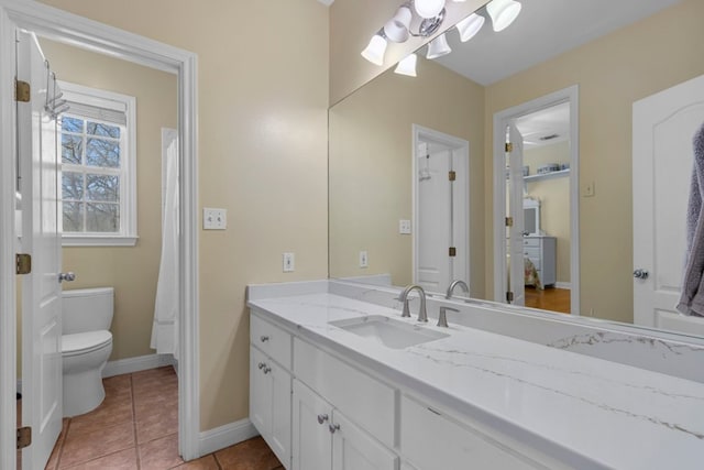 full bath with baseboards, vanity, toilet, and tile patterned floors