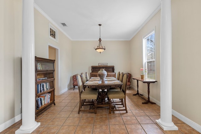 dining area featuring crown molding, light tile patterned floors, baseboards, and ornate columns