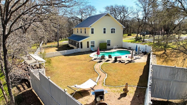 exterior space with a patio area, a fenced backyard, a fenced in pool, and a yard