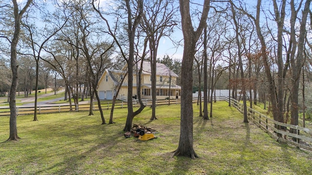 view of yard with a garage and fence