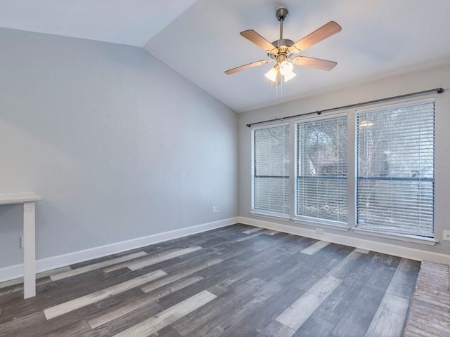 unfurnished room with lofted ceiling, ceiling fan, wood finished floors, and baseboards