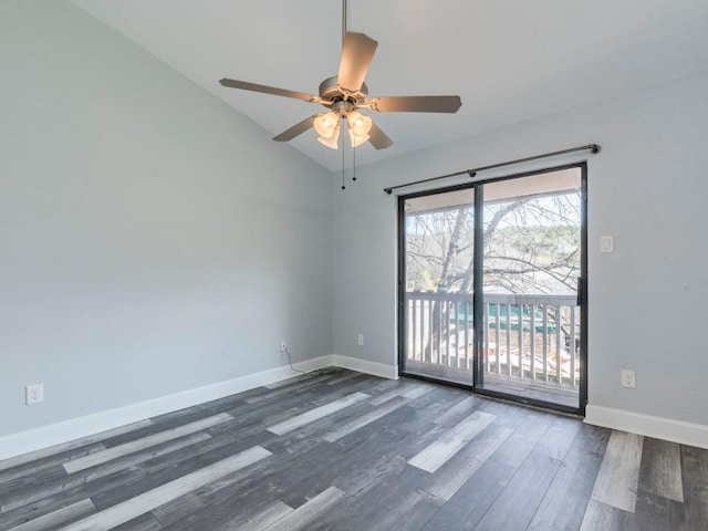 spare room featuring lofted ceiling, wood finished floors, a ceiling fan, and baseboards