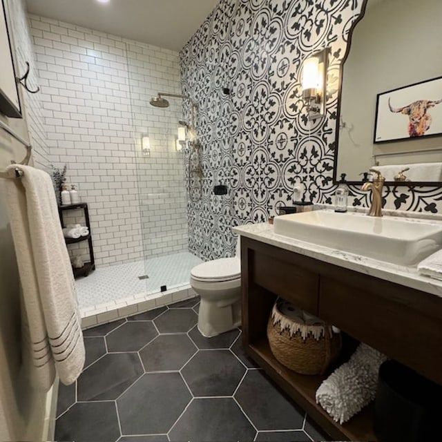 full bath with toilet, walk in shower, a sink, and tile patterned floors