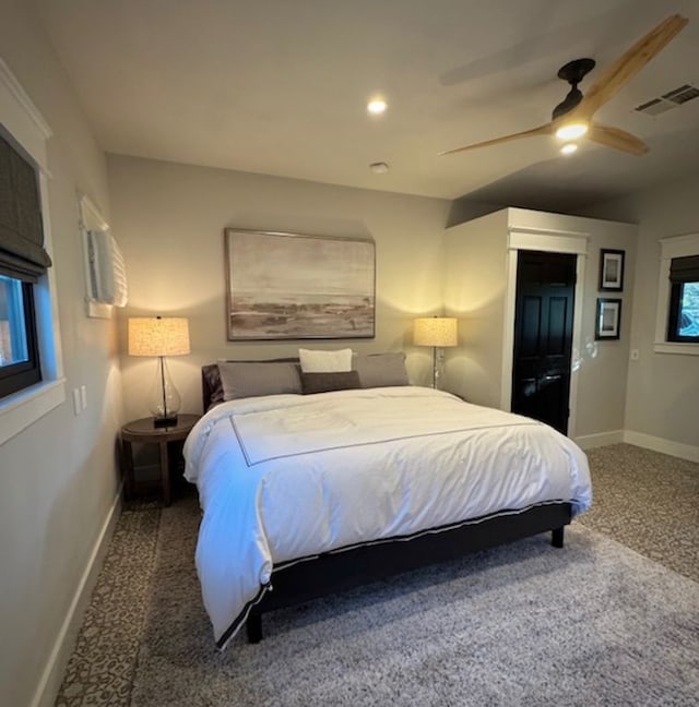 carpeted bedroom with a ceiling fan, recessed lighting, visible vents, and baseboards