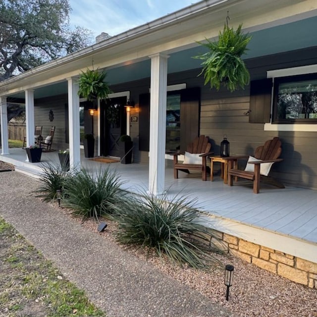 back of property featuring covered porch