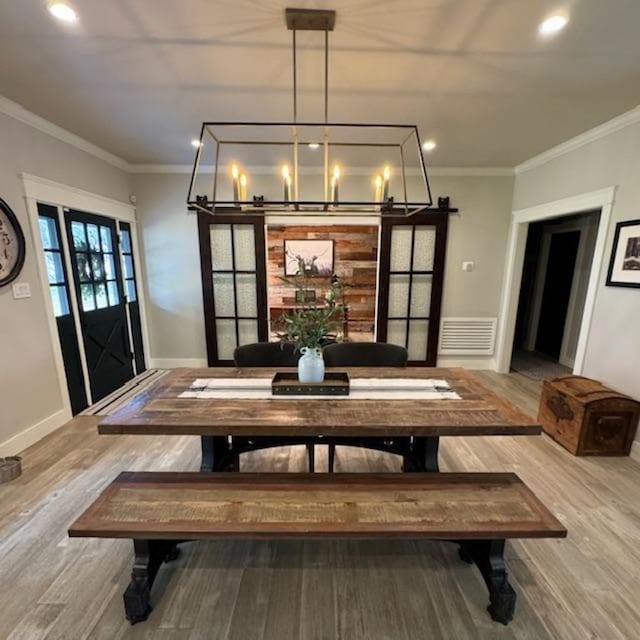 dining space featuring ornamental molding, recessed lighting, wood finished floors, and baseboards