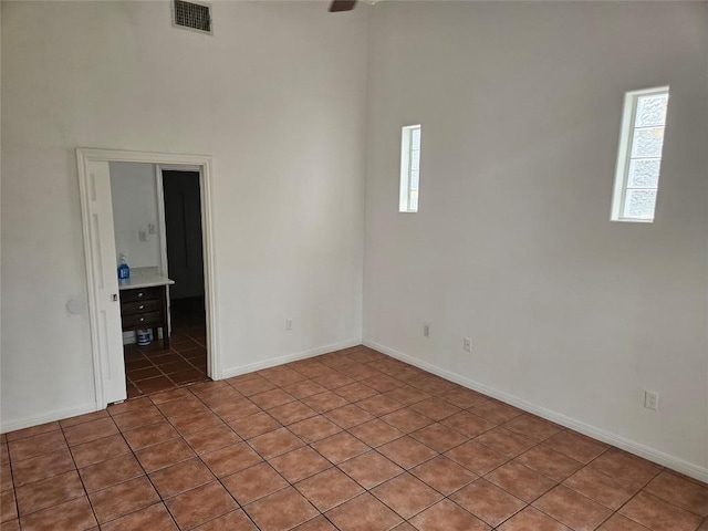 unfurnished room with baseboards, visible vents, and a wealth of natural light