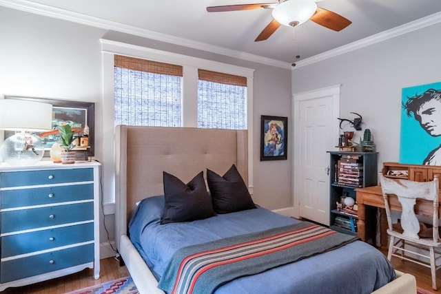 bedroom featuring ceiling fan, ornamental molding, and wood finished floors