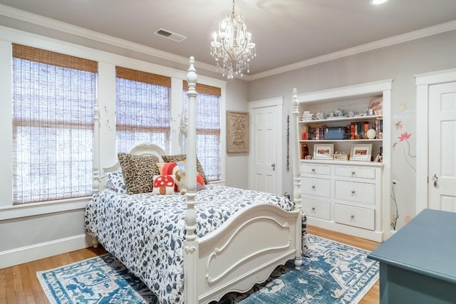 bedroom featuring ornamental molding, light wood-style flooring, multiple windows, and visible vents