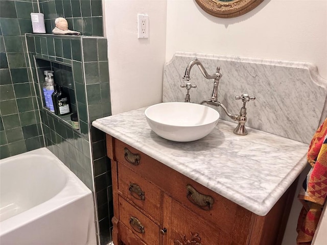 bathroom with a washtub and vanity