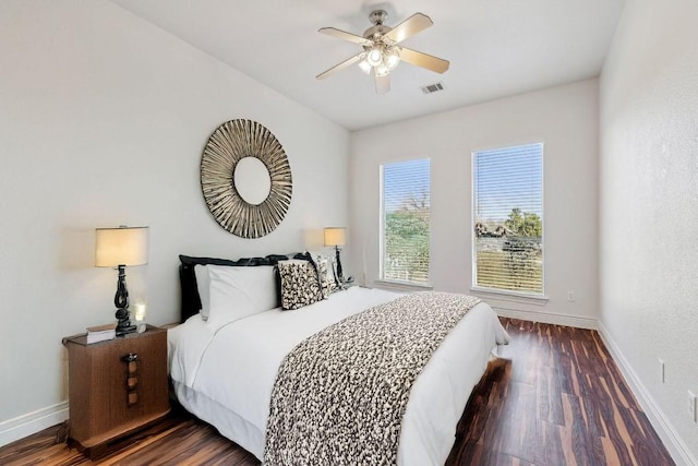 bedroom featuring baseboards, visible vents, ceiling fan, and dark wood-style flooring