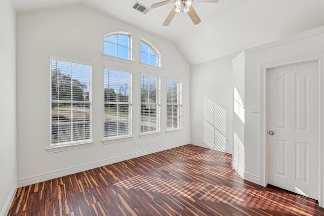 unfurnished room with vaulted ceiling, dark wood-style floors, visible vents, and baseboards