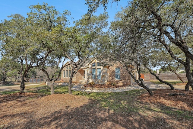 view of front of house featuring fence